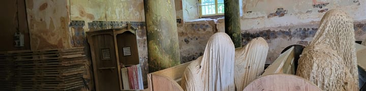 Sculptures of shrouded figures in the ruins of a defunct church. [Taken at the Kostel Svatého Jiří]