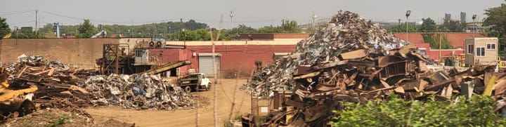 Heaps of rusted metal in a scrapyard. 