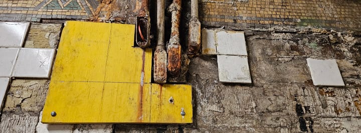 Rotting subway station walls, corroded electrical wiring, falling tiles exposing filthy walls. 