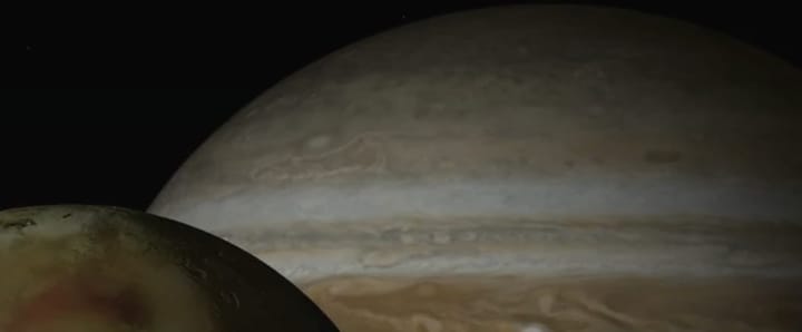 NASA photo of Io in the foreground and Jupiter in the background. 